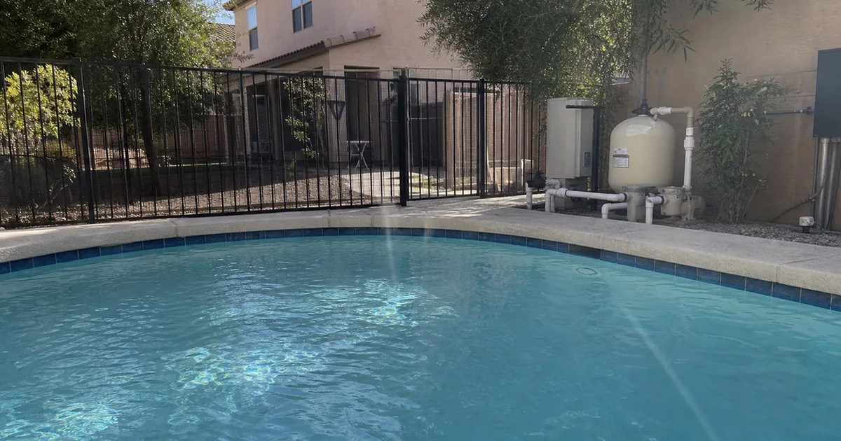 Home inspector checking the pump, filter, and heater on the equipment pad of a Beverly Hills estate pool