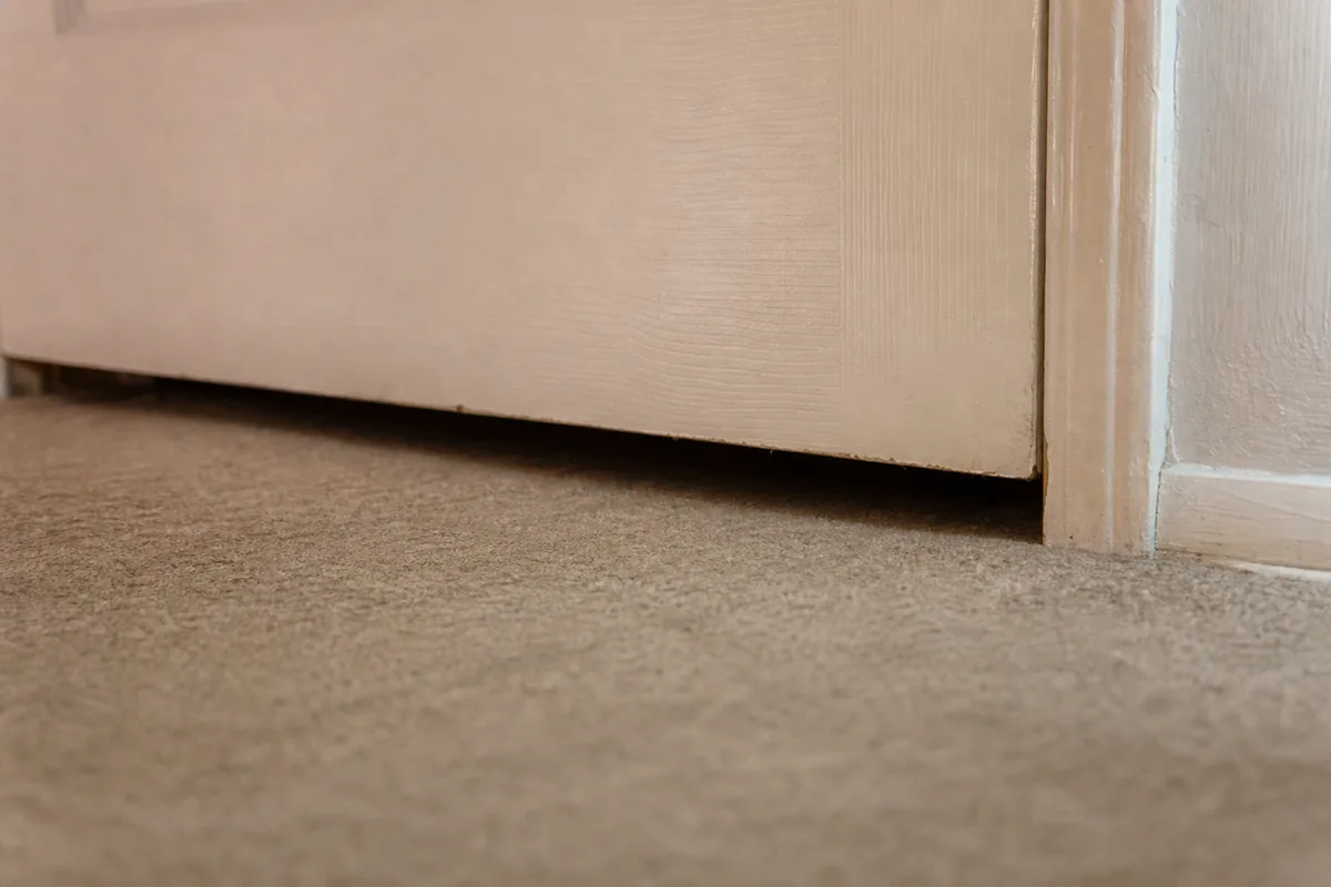 Interior door with an enlarged undercut gap installed as a makeshift return air path in an older tract home
